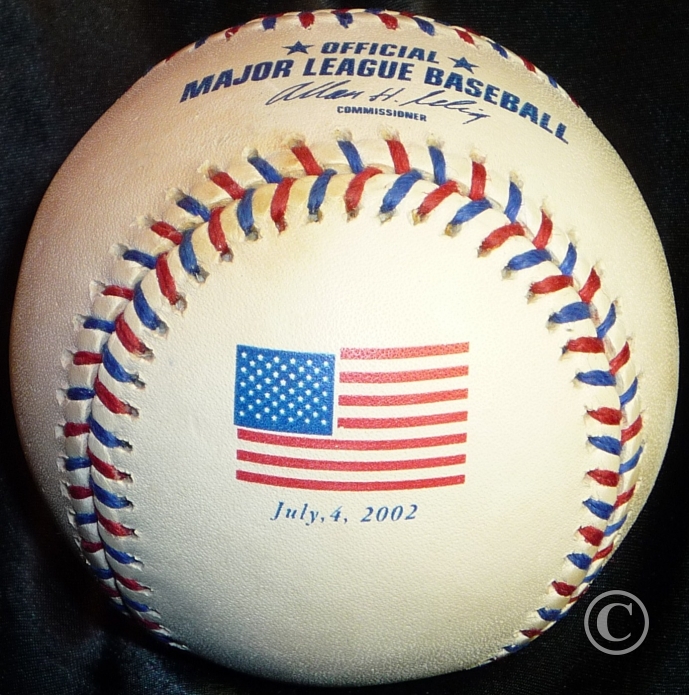 MLB 2002 Rawlings July 4th 2002 American Flag ROMLB Baseball Red-White-and-Blue Commemorative Logo Ball. This image belongs to OfficialGameBalls.com Big League Baseballs and Big League Authentics. MLB ROMLB RO-A RO-N special event commemorative baseballs, logoballs on-field leather game balls.
