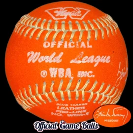 Close-up of a WBA 1970s Worth World Baseball Association orange night game baseball showing the white ink logo stamps.